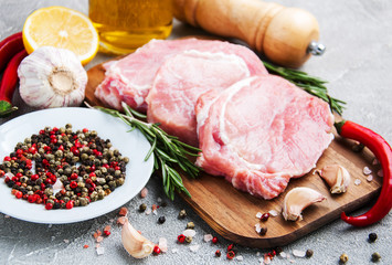 Fresh raw pork chops with spices and herbs