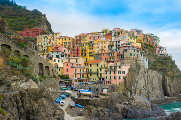 Fototapeta na wymiar The small traditional Italian village of Manarola with colorful houses now a popular tourist destination in Cinque terre, Liguria, Italy
