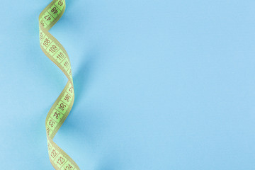 Tape measure on blue color background