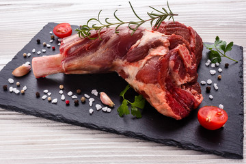 fresh lamb meat on a textured stone plate