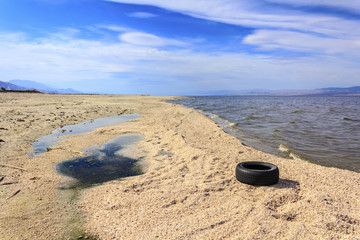 Old tire near abandoned Salton Riviera, Salton Sea, CA, USA.