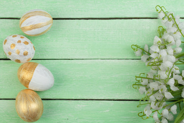 Happy Easter. Painted eggs on wooden table. Top view. Copy space for text.