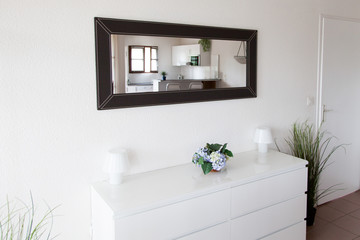 Design of classic hall. Mirror wall, console of a white interior house