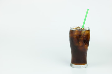 cold cola with ice in a glass on white background