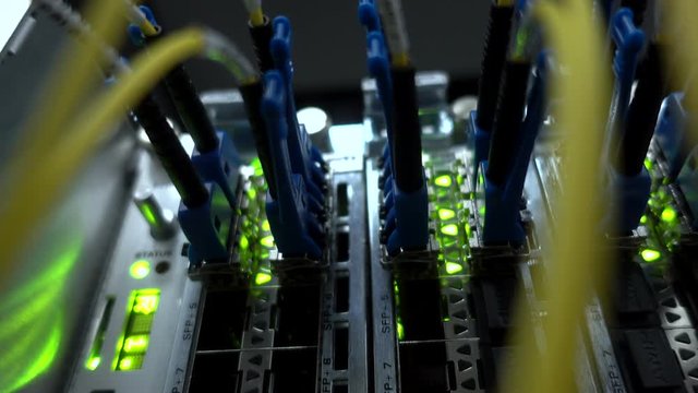 Fiber Optical connector interface. Rack Mounted Servers In A Server Room, Server rack audio cable. Severs computer in a rack at the large data center. Flashing Lamp. Contains little noise.  - Powered by Adobe
