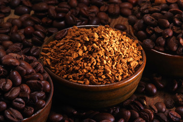 Coffee beans pile and coffe instant on the background of ground coffee