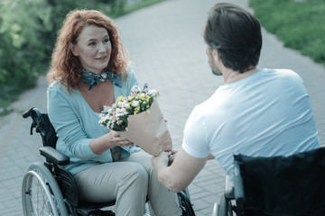 From me with love. Happy differently abled female keeping smile on her face while looking at her...