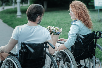 Look at me. Cheerful differently abled people looking at each other and expressing positivity while meeting in the park