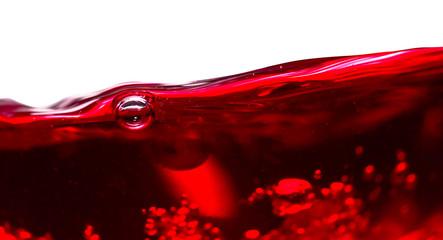 Red wine on white background.