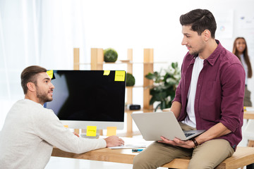 selective focus of businessmen working at workplace together in office