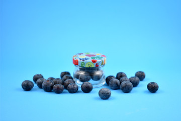 Blueberries in a jar stock images. Blueberries on a blue background