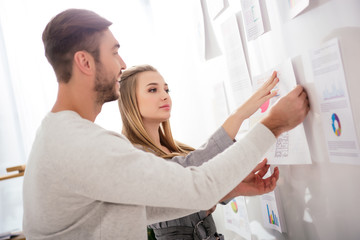 Fototapeta premium business colleagues putting document at white board with papers in office