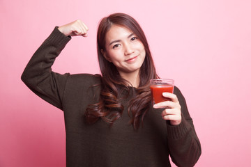 Strong healthy Asian woman with tomato juice.