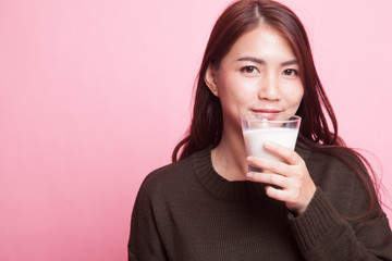 Healthy Asian woman drinking a glass of milk.