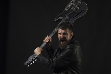Fototapeta na wymiar Angry man with beard hold musical instrument