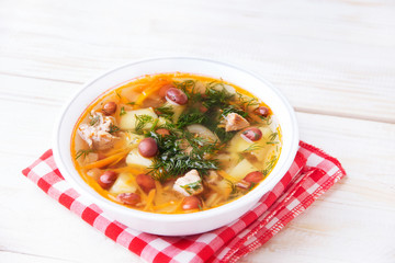 Soup with beans on a wooden table