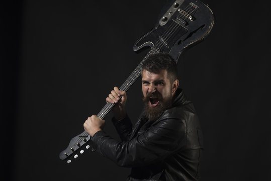 Angry man with beard hold musical instrument