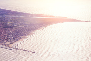 Top view of the city on the sea coast in the sunlight