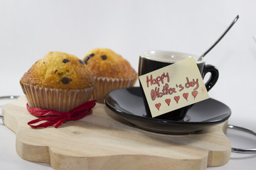 background for mother's day, with muffin cakes, coffee and a greeting card