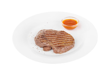 Steak beef, pork, lamb, grilled meat, barbecue, on a plate isolated white background. Tomato, spicy, red sauce. Juicy fillet, medium, strong roast. For the menu in the restaurant, bar Side view
