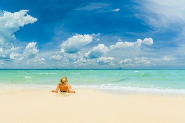 Fototapeta na wymiar WOman alone on the beach in the Caribbean islands