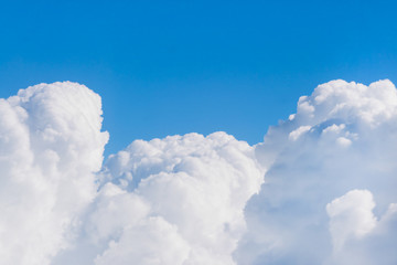Naklejka premium White fluffy clouds against a blue sky, background