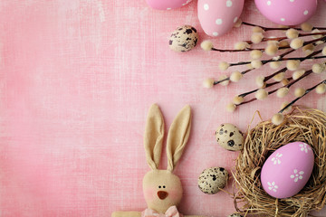 easter eggs, bunny and pussy willow on pink background