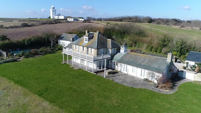 Aerial footage of typical british home located on countryside also showing South Foreland Lighthouse in background is Victorian lighthouse on South Foreland in St. Margarets Bay Dover Kent England 4k