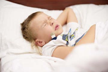 little boy measures the temperature. selective focus