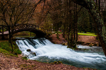 Small waterfall under the wooden bridge
