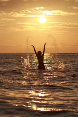 Beautiful Woman in the Sea Waves and Enjoying Sunshine with Open Arms