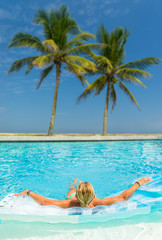 Woman at the swimming pool at the tropical resort