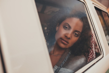 Thoughtful woman travelling by a van