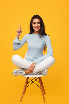 Smart Girl Gesturing On Chair