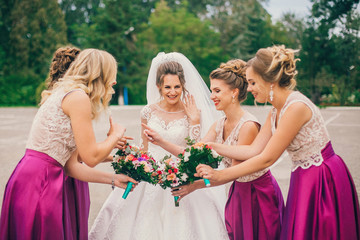 Bride With Bridesmaids On Wedding Day. Bride show bridesmaids her new ring. The girls laugh. Funny wedding moments.