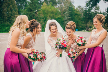 Bride With Bridesmaids On Wedding Day. Bride show bridesmaids her new ring. The girls laugh. Funny wedding moments.