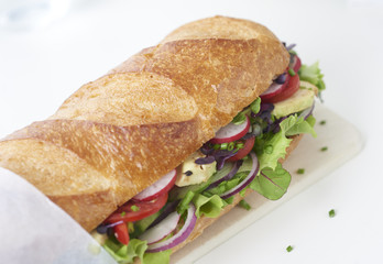 close up of fresh sandwich on plate of wood
