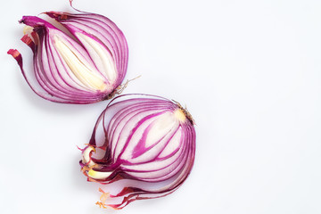 Red onion cut in half on a white background