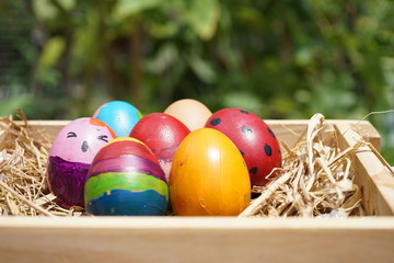 Conceptual colorful fancy easter eggs in wooden box