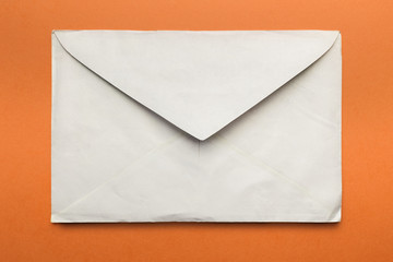 Old envelope open, isolated on orange background