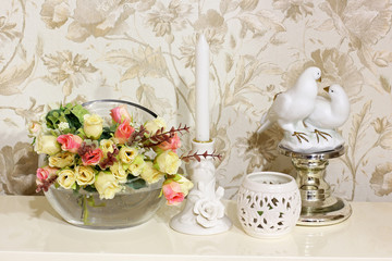 Beautiful composition. Flowers, a vase and a candle. Rose