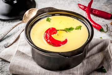 Traditional Indian cuisine. Vegetarian curry Gujarati Kadhi, Gujarati daal soup, with spices on grey stone background copy space