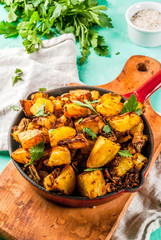 Indian food, Bombay Potatoes on light blue background copy space