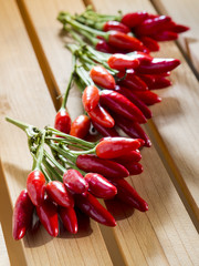 Red pepperoni peppers on a wooden table