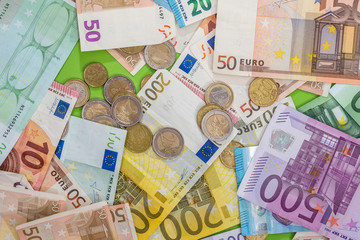 different euro banknotes and coin as background