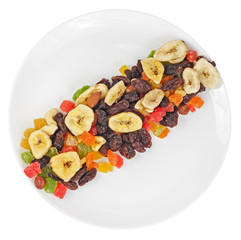 Top view of dried fruits in plate isolated on white