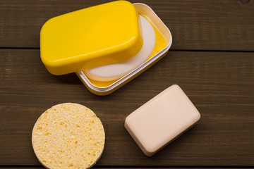 Shower set. Toiletries. Wisp, soap, sponge and comb. Bodycare kit. Yellow combo. Start of the day. Water procedures.