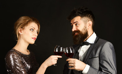 Couple in love holding glasses of red wine