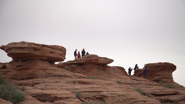 Tourists on red rocks
