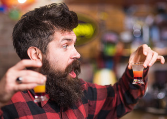 Man with cheerful face sit alone at bar counter.